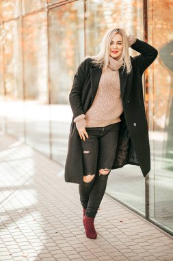 35 yaşındaki modern özgüvenli kadın portresi. Siyah ceketli ve kot pantolonlu. Sonbahar günü ensest poz veriyor. Sonbahar engizisyonu. Yılın mevsimleri. Güzellik ve zarafet. Büyürken. Turizm ve seyahat. 