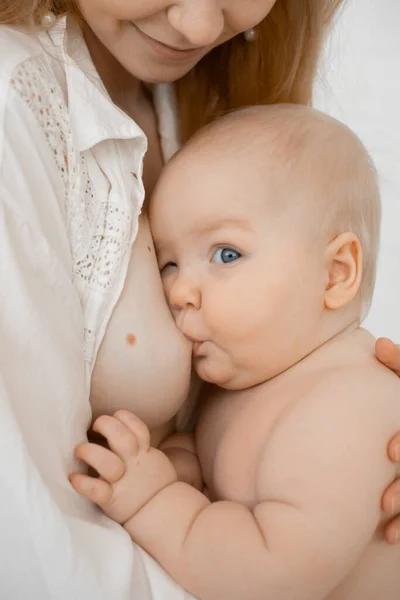 Vertical cropped of bare woman with small baby eating, breastfeeding, mother nursing newborn. Nipple to kid, lactation — Stock Photo, Image