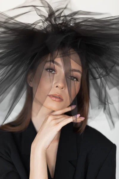 Close up vertical portrait of attractive, mystery, fashionable brunette woman in black dress and veil. Mourning outfit. — ストック写真