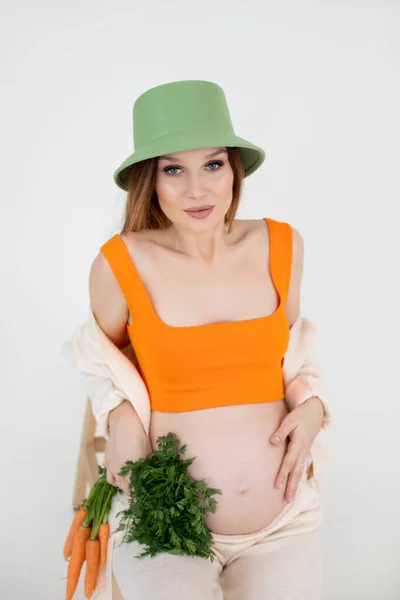 Vertical Close Photo Pregnant Woman Green Hat Orange Top Flax — стоковое фото