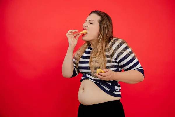 Overweight Adipose Woman Naked Belly Striped Clothes Holding Eating Potato — стоковое фото