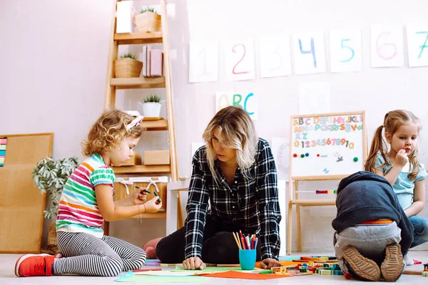 Kids Educator Folding Lego Drawing Colored Pencils Markers Sitting Floor — Zdjęcie stockowe