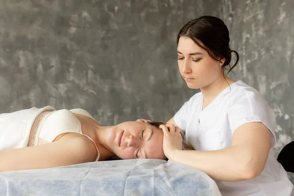 Side View Young Masseuse Doctor Therapist Massaging Head Young Woman — Zdjęcie stockowe