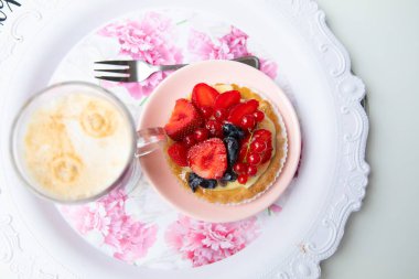 Vegan strawberry, raspberry, cherry, blueberry pancake or cupcake on plate with fork and mousse cream. Open new cafe or bakery. Dessert table, festive party. Catering service for outdoor celebration.