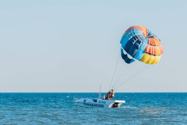 Ukrayna, Demir Liman - 31 Ağustos 2020: Ekstrem sporlar ve heyecan verici dinlenme aktiviteleri. Denizdeki bir motorlu teknede bir insan paraşütle gezici bir turist başlatacak..