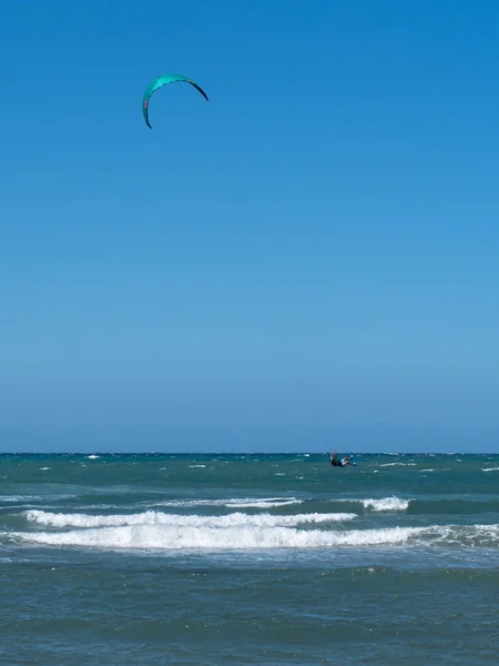 Kitesurfing During a Windy Day with a Very Rough Sea.