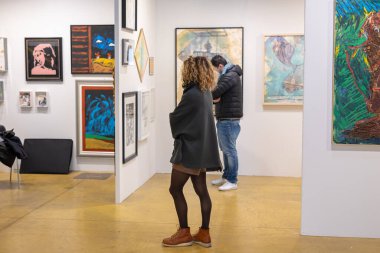 Bir Modern Sanat Galerisinde Eserlerin SatınAlınmasını Değerlendiren Alıcılar.