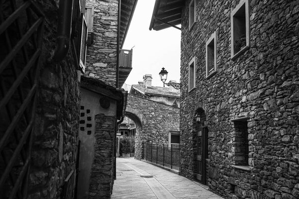 Black and white Photo of a Road without People with Rock Dwellings in Morgex in Aosta Valley, Italy.
