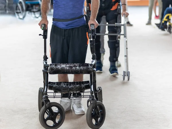 Boy with Reduced Motor Skills who move in Upright Posture with the Support of Walker Trolleys.