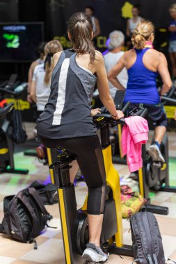 Girl Having Workout at Gym with Indoor Bike.