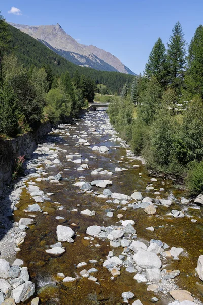 Mountain Stream and the Mountain Range of the Italian Alps on a Sunny Summer Day.