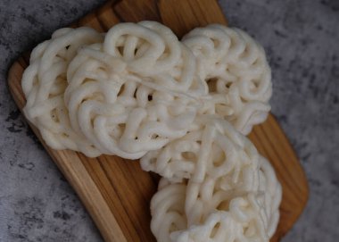 Krupuk ya da Kerupuk, geleneksel Endonezya krakerleri, ahşap tabakta servis edilir. Gri arka plan. Seçici Odaklanma