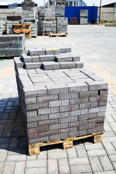 Concrete paving slabs stacked on pallets outdoor of workshop — ストック写真