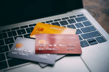 Close up multiple credit cards placed on the laptop. online shopping payment and retail concepts. mockup and fake credit card.