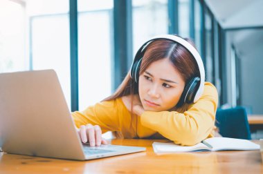 Female students are bored and sleepy during online classes while sitting online for long hours.