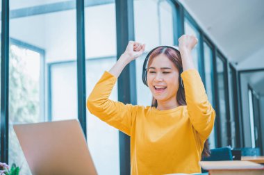 Female students are delighted to see results of their exams and get good grades while studying online.