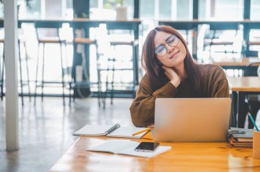 young student wearing headphones studies online, distance learning, and keeps up to date on the global coronavirus pandemic.