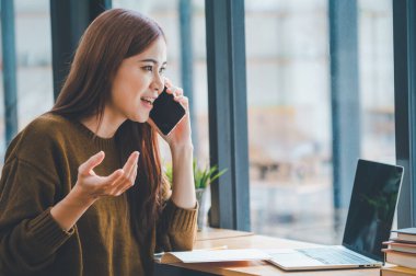 young student wearing headphones studies online, distance learning, and keeps up to date on the global coronavirus pandemic.	