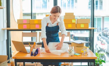 Online small business owners are packing their ordered products into the boxes for their customers based on the concept of online shopping - online shopping.