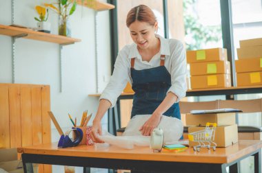 Online small business owners are packing their ordered products into the boxes for their customers based on the concept of online shopping - online shopping.