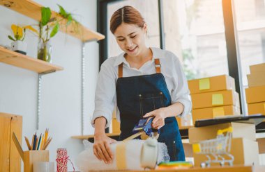 Online small business owners are packing their ordered products into the boxes for their customers based on the concept of online shopping - online shopping.