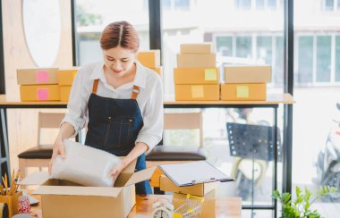 Online small business owners are packing their ordered products into the boxes for their customers based on the concept of online shopping - online shopping.