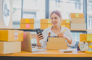 Small business owners online are writing their names and addresses to deliver products and products to their customers. and check the orders that the customers have ordered of online retailers - online shopping