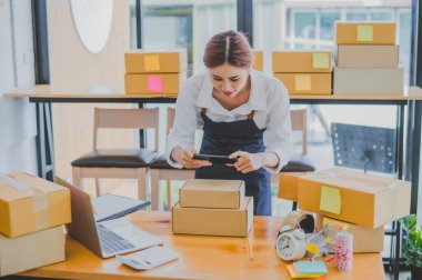 Small business owners online are taking pictures of their products and offering them to customers who will place their orders. and check the orders that the customers have ordered of online retailers - online shopping