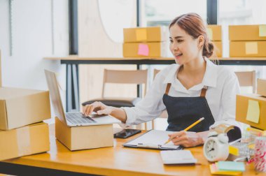 Small business owners online are taking orders and products that their customers have ordered. and check the orders that the customers have ordered of online retailers - online shopping