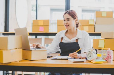Small business owners online are taking orders and products that their customers have ordered. and check the orders that the customers have ordered of online retailers - online shopping