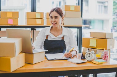 Small business owners online are taking orders and products that their customers have ordered. and check the orders that the customers have ordered of online retailers - online shopping