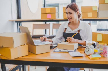 Small business owners online are writing their names and addresses to deliver products and products to their customers. and check the orders that the customers have ordered of online retailers - online shopping