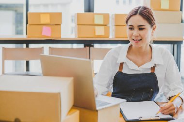 Small business owners online are taking orders and products that their customers have ordered. and check the orders that the customers have ordered of online retailers - online shopping