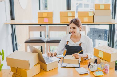 Small business owners online are writing their names and addresses to deliver products and products to their customers. and check the orders that the customers have ordered of online retailers - online shopping