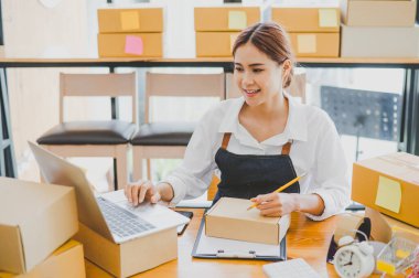 Small business owners online are writing their names and addresses to deliver products and products to their customers. and check the orders that the customers have ordered of online retailers - online shopping