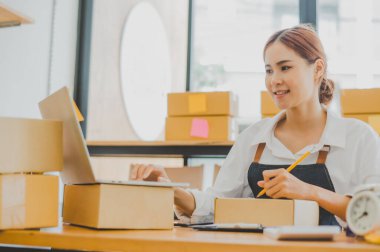 Small business owners online are writing their names and addresses to deliver products and products to their customers. and check the orders that the customers have ordered of online retailers - online shopping