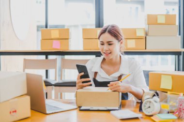 Small business owners online are writing their names and addresses to deliver products and products to their customers. and check the orders that the customers have ordered of online retailers - online shopping