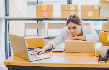 Online small business owners are sad and bored waiting for orders that haven't yet arrived. Online Retailers - Online Shopping