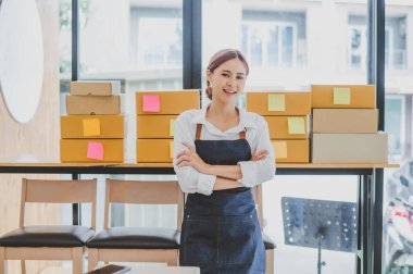 Small business owners online are smiling. and happy to work at a parcel delivery business offering orders and products to its customers online retailer - online shopping.