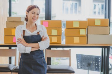 Small business owners online are smiling. and happy to work at a parcel delivery business offering orders and products to its customers online retailer - online shopping.
