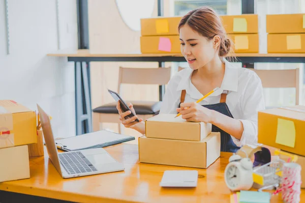 Small business owners online are writing their names and addresses to deliver products and products to their customers. and check the orders that the customers have ordered of online retailers - online shopping