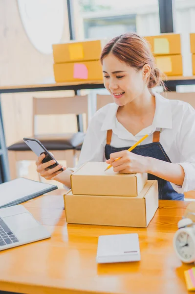 Small business owners online are writing their names and addresses to deliver products and products to their customers. and check the orders that the customers have ordered of online retailers - online shopping