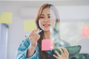 Web designers creating planning and analyzing with Colorful sticky notes on the office board.web design concept