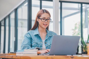 young student wearing small talk studies online, distance learning, and keeps up to date on the global coronavirus pandemic
