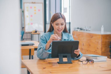 young student wearing small talk studies online, distance learning, and keeps up to date on the global coronavirus pandemic
