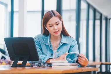 young student wearing small talk studies online, distance learning, and keeps up to date on the global coronavirus pandemic