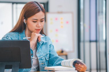 young student wearing small talk studies online, distance learning, and keeps up to date on the global coronavirus pandemic