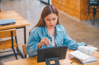 young student wearing small talk studies online, distance learning, and keeps up to date on the global coronavirus pandemic