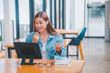 young student wearing small talk studies online, distance learning, and keeps up to date on the global coronavirus pandemic