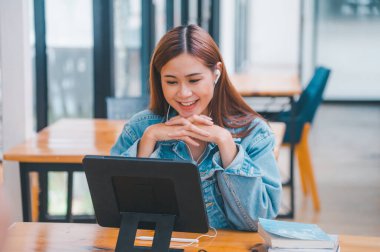 young student wearing small talk studies online, distance learning, and keeps up to date on the global coronavirus pandemic